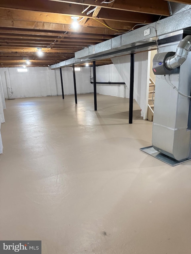 unfinished below grade area featuring heating unit