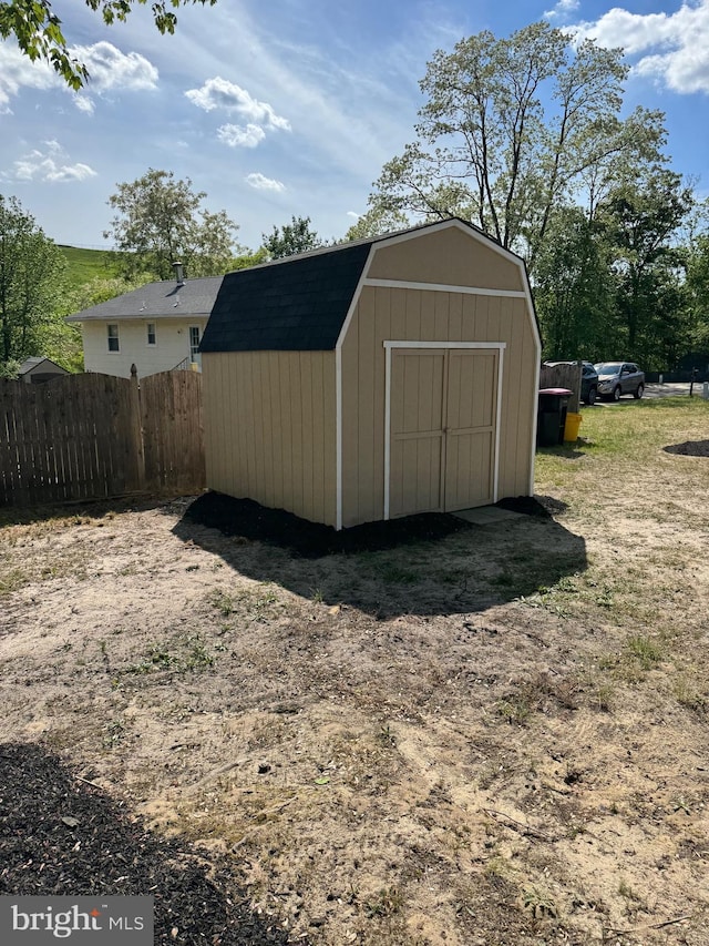 view of shed featuring fence