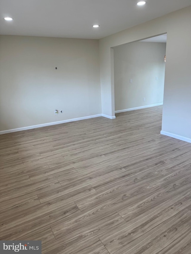 unfurnished room featuring recessed lighting, baseboards, and wood finished floors