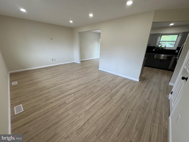 unfurnished room with light wood-type flooring, baseboards, and recessed lighting