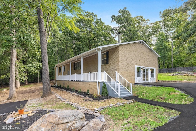 194 Black Cub Run Ln, Harpers Ferry, WV 25425 - view of front of house featuring a porch, brick siding, french doors, and fence