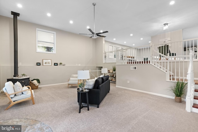 194 Black Cub Run Ln, Harpers Ferry, WV 25425 - living room featuring a wood stove, carpet, baseboards, recessed lighting, and stairs