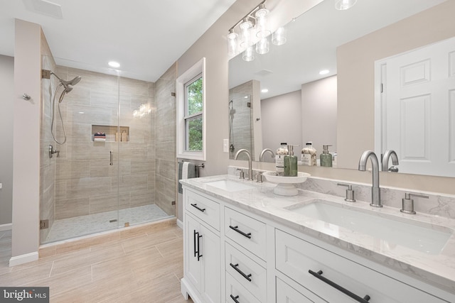 194 Black Cub Run Ln, Harpers Ferry, WV 25425 - bathroom with a stall shower, double vanity, baseboards, and recessed lighting