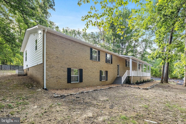 194 Black Cub Run Ln, Harpers Ferry, WV 25425 - back of house with brick siding, covered porch, and fence