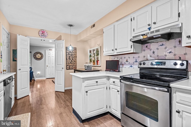 352 Paoli Woods Dr, Paoli, PA 19301 - kitchen with stainless steel appliances, under cabinet range hood, a peninsula, and white cabinetry