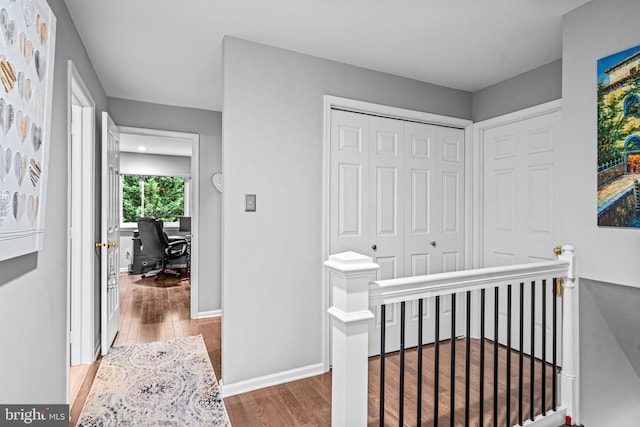 352 Paoli Woods Dr, Paoli, PA 19301 - hallway featuring an upstairs landing, wood finished floors, an office area, and baseboards