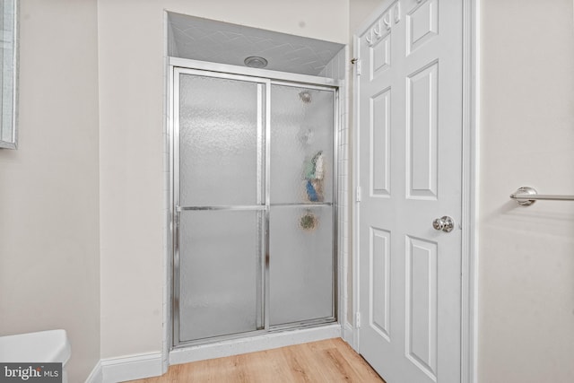 352 Paoli Woods Dr, Paoli, PA 19301 - bathroom featuring a stall shower, wood finished floors, and toilet