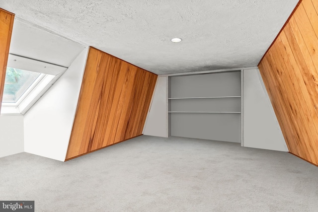 352 Paoli Woods Dr, Paoli, PA 19301 - bonus room featuring light carpet, a textured ceiling, wood walls, and a skylight