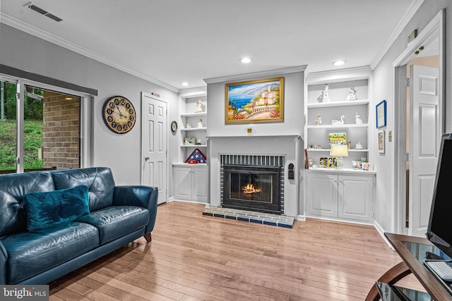352 Paoli Woods Dr, Paoli, PA 19301 - living area featuring ornamental molding, hardwood / wood-style floors, a brick fireplace, built in shelves, and recessed lighting