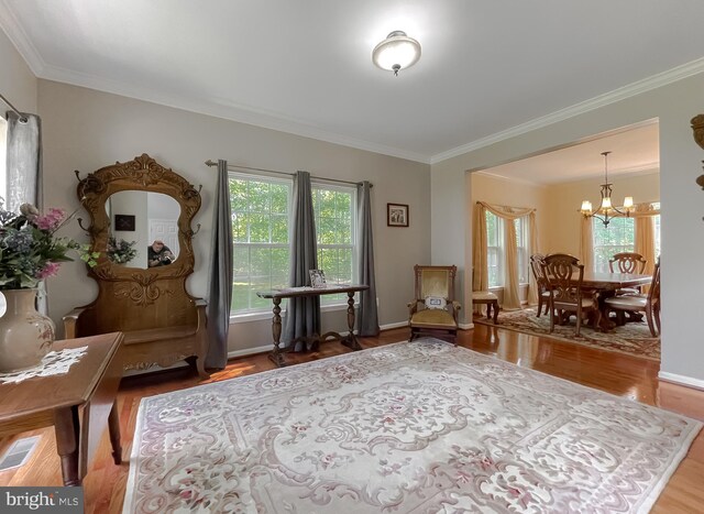 13605 Sugar Mill Ct, Waldorf, MD 20601 - sitting room featuring a chandelier, crown molding, wood finished floors, and baseboards