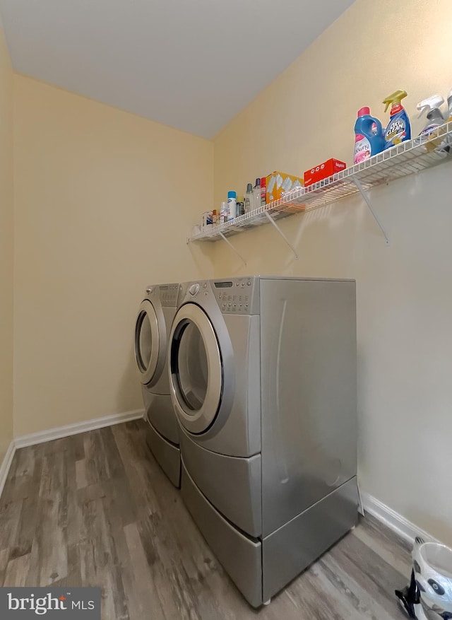 13605 Sugar Mill Ct, Waldorf, MD 20601 - laundry room featuring separate washer and dryer, wood finished floors, and baseboards