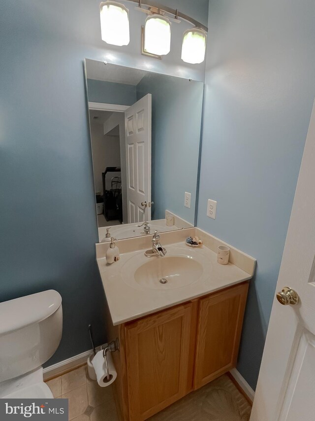 13605 Sugar Mill Ct, Waldorf, MD 20601 - bathroom with toilet, vanity, tile patterned floors, and baseboards