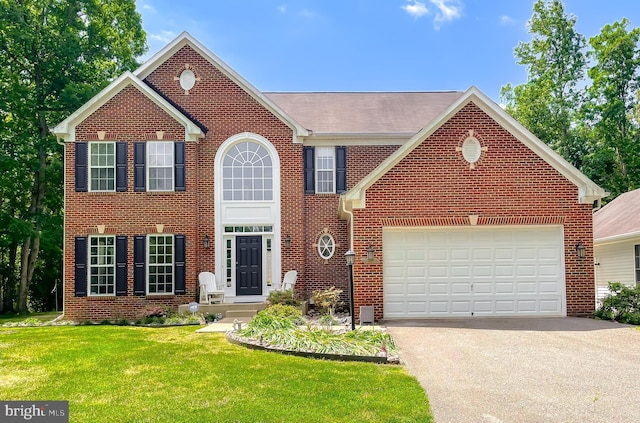 13605 Sugar Mill Ct, Waldorf, MD 20601 - colonial home with brick siding, asphalt driveway, a front lawn, and an attached garage