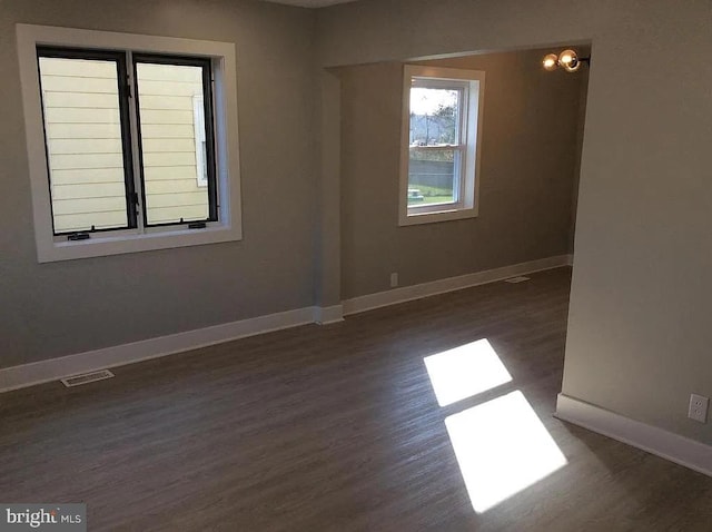 empty room with wood finished floors and baseboards