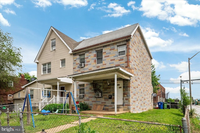 28 Talbott St, Baltimore, MD 21225 - rear view of property with stone siding, cooling unit, and roof with shingles