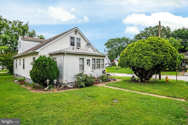 216 Charles St, Baltimore, MD 21225 - view of side of home with a yard and a shingled roof