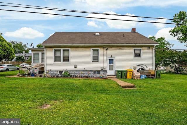 216 Charles St, Baltimore, MD 21225 - rear view of house featuring a yard, a chimney, and roof with shingles
