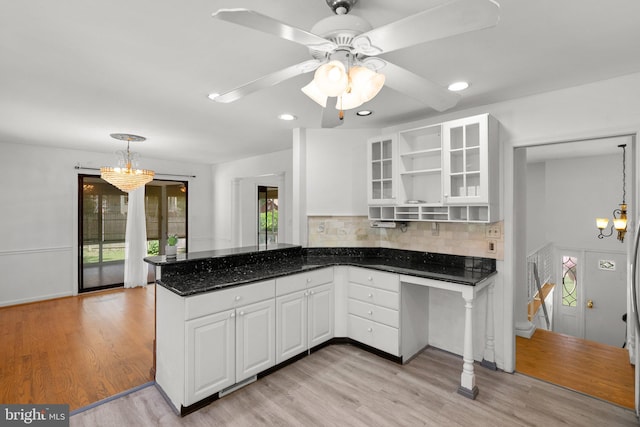 kitchen with a chandelier, open shelves, white cabinetry, light wood-style floors, and recessed lighting