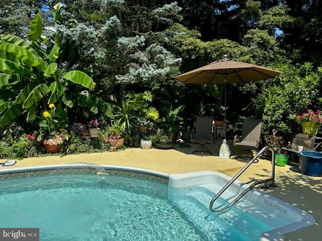swimming pool with a patio area