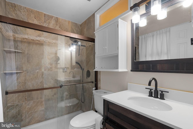 full bath with toilet, a stall shower, and vanity