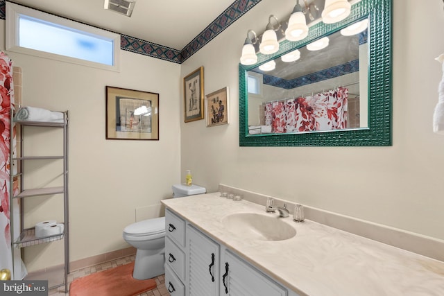bathroom with toilet, vanity, curtained shower, and tile patterned flooring