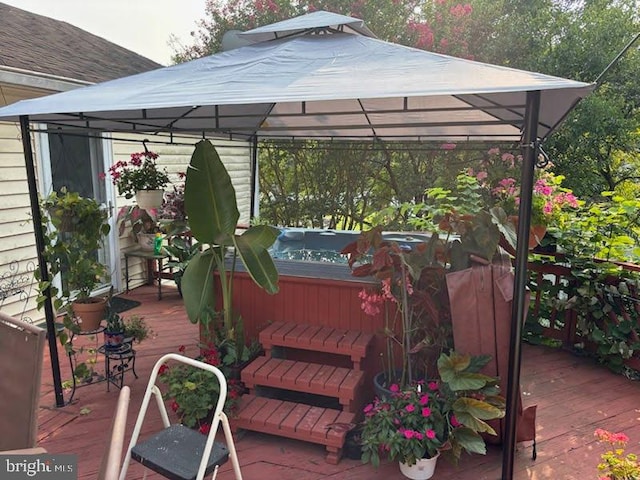 deck featuring a gazebo and a jacuzzi