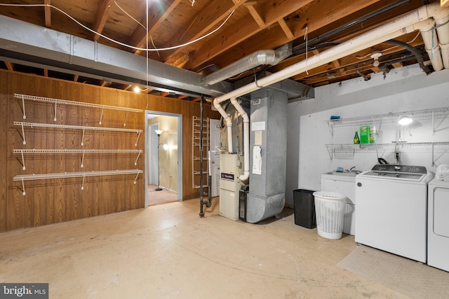 unfinished below grade area with washing machine and dryer and heating unit
