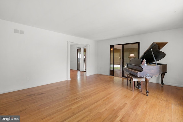 living area featuring light wood-style floors and baseboards