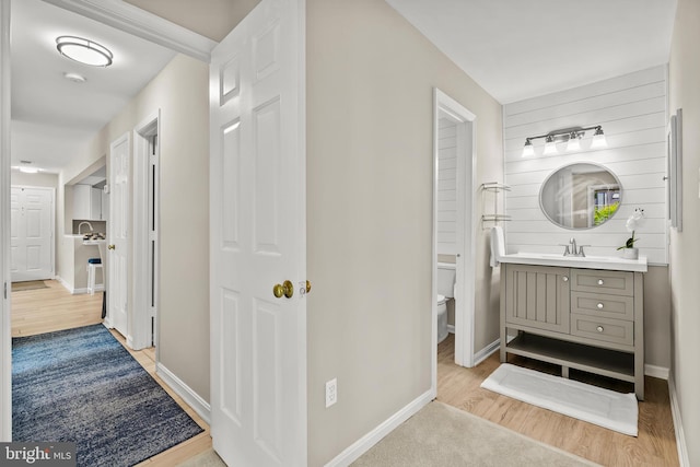 2224 Springwood Dr Unit 102A, Reston, VA 20191 - corridor featuring light wood-type flooring, baseboards, and a sink