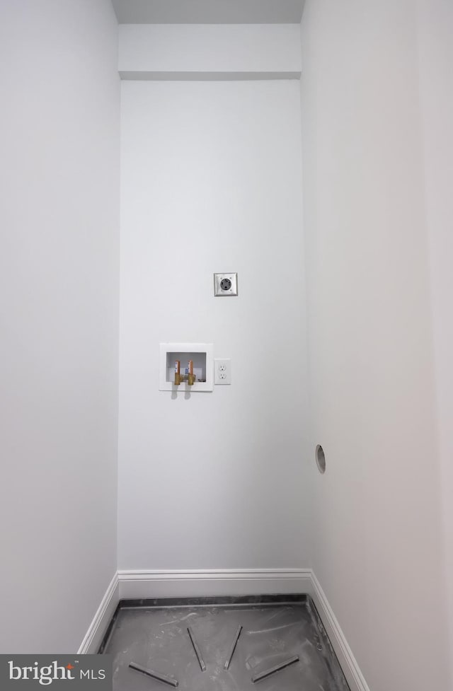 washroom with hookup for an electric dryer, baseboards, and hookup for a washing machine