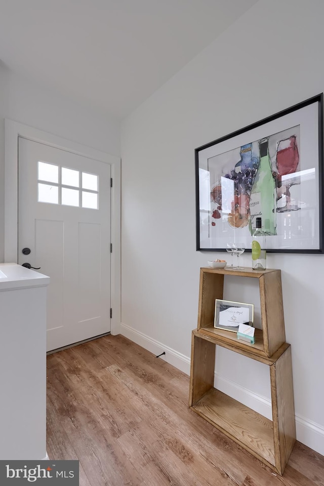 entrance foyer with wood finished floors and baseboards