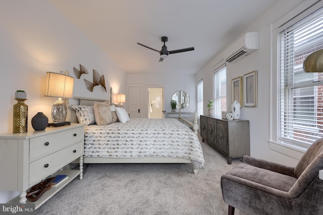 bedroom with a wall unit AC, light carpet, and a ceiling fan