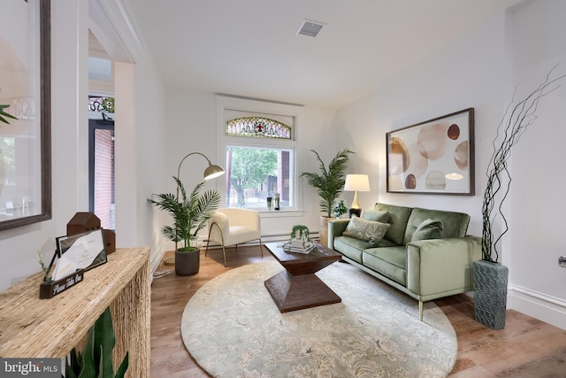 living room with wood finished floors and baseboards
