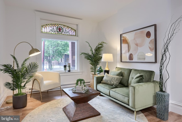 living area with wood finished floors and baseboards