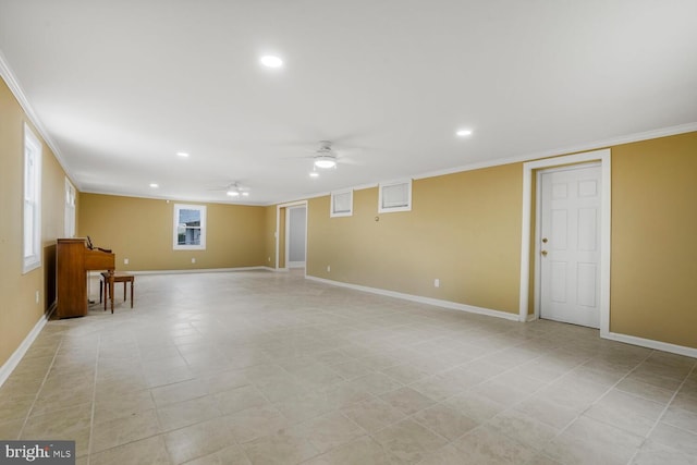 below grade area featuring ornamental molding, ceiling fan, baseboards, and recessed lighting