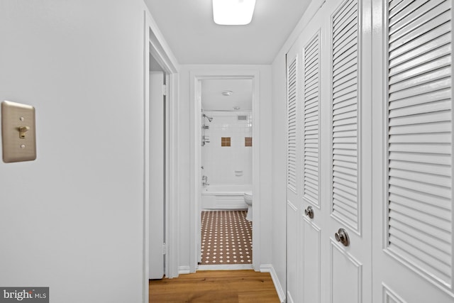 hallway with light wood-style floors