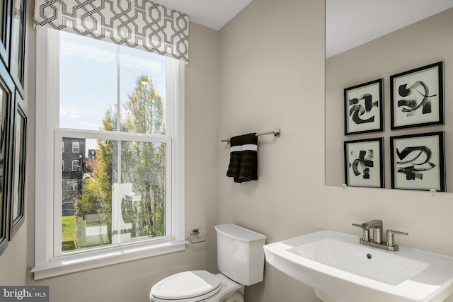 half bathroom with toilet and a sink