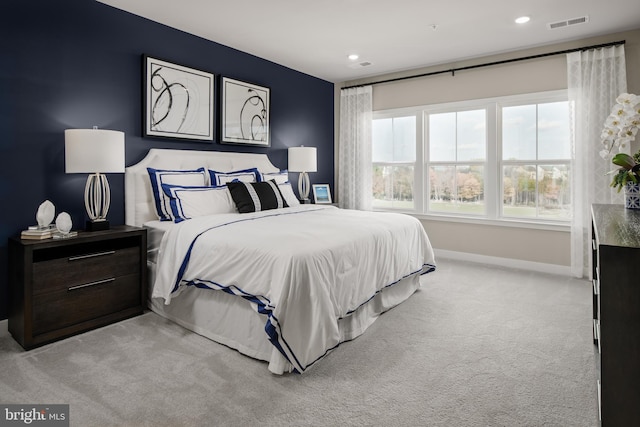 bedroom featuring light carpet, baseboards, and recessed lighting