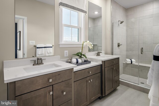 bathroom featuring a stall shower, two vanities, and tile patterned flooring