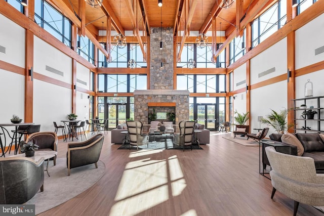 community lobby featuring wooden ceiling, a towering ceiling, and beam ceiling