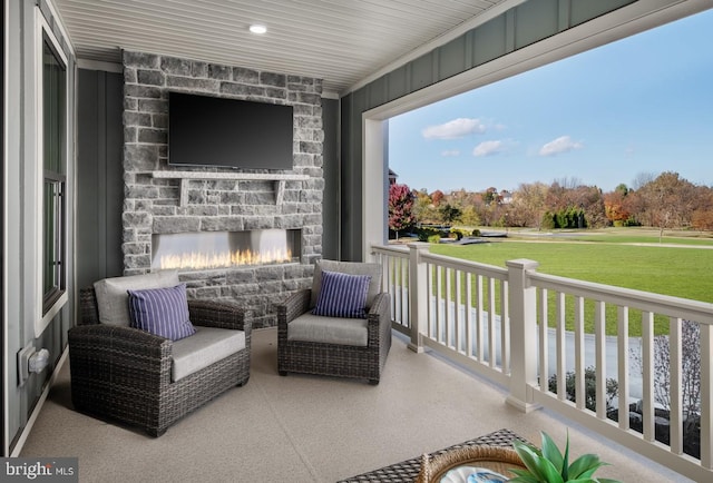 view of patio / terrace featuring an outdoor stone fireplace and covered porch