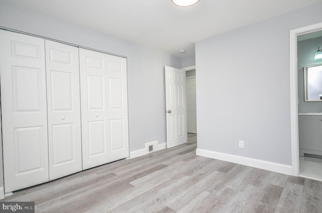 7009 Adelphi Rd, Hyattsville, MD 20782 - unfurnished bedroom with wood finished floors, a closet, ensuite bath, and baseboards
