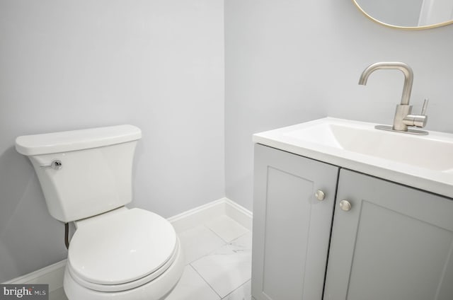 7009 Adelphi Rd, Hyattsville, MD 20782 - half bathroom featuring marble look tiles, vanity, and toilet