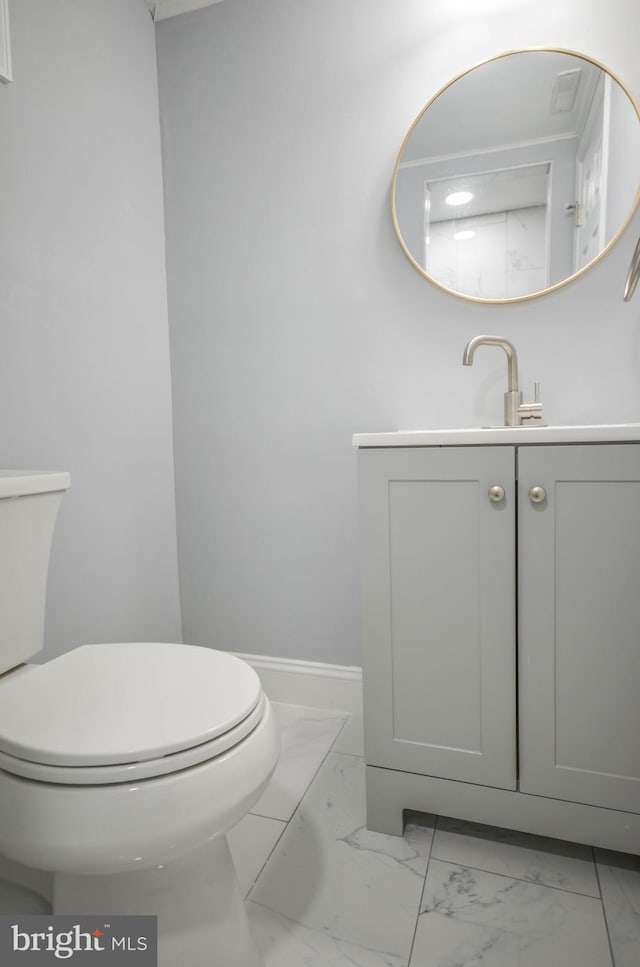 7009 Adelphi Rd, Hyattsville, MD 20782 - bathroom with marble look tiles, toilet, vanity, and baseboards