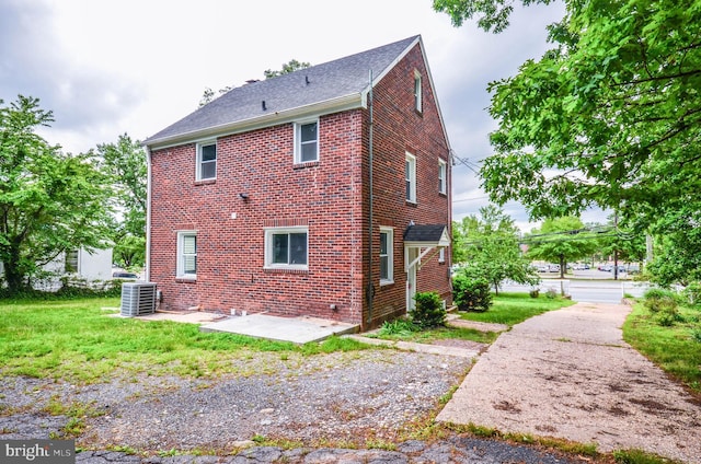 7009 Adelphi Rd, Hyattsville, MD 20782 - rear view of house with cooling unit and brick siding
