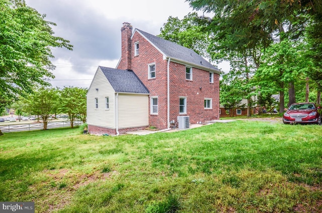 7009 Adelphi Rd, Hyattsville, MD 20782 - view of property exterior with cooling unit, a chimney, a lawn, and a shingled roof
