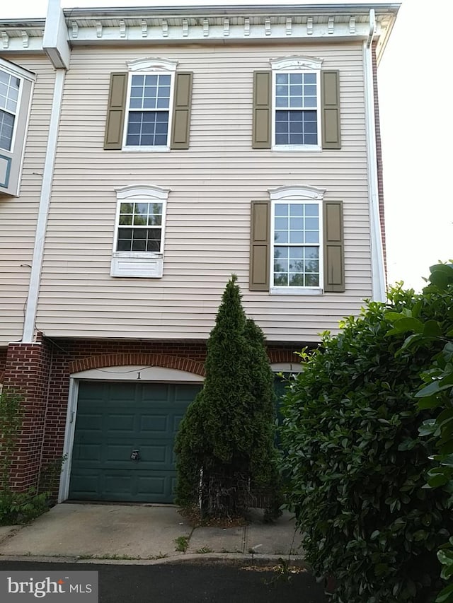 view of property exterior with an attached garage