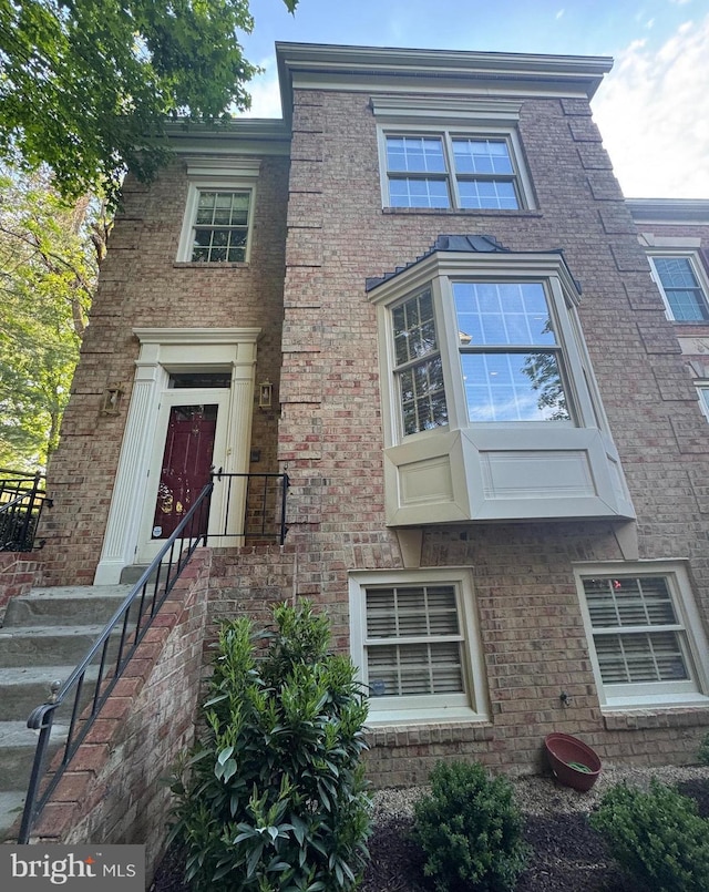 view of front of home featuring brick siding