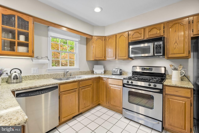 10938 Rocky Mount Way, Silver Spring, MD 20902 - kitchen featuring appliances with stainless steel finishes, a sink, light tile patterned floors, glass insert cabinets, and recessed lighting