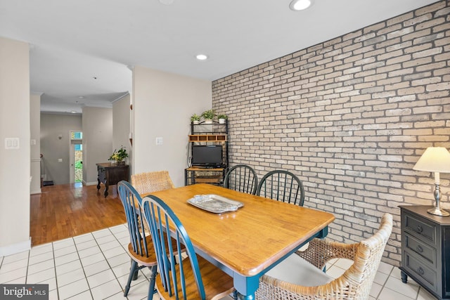 10938 Rocky Mount Way, Silver Spring, MD 20902 - dining room with brick wall, light tile patterned floors, recessed lighting, baseboards, and an accent wall